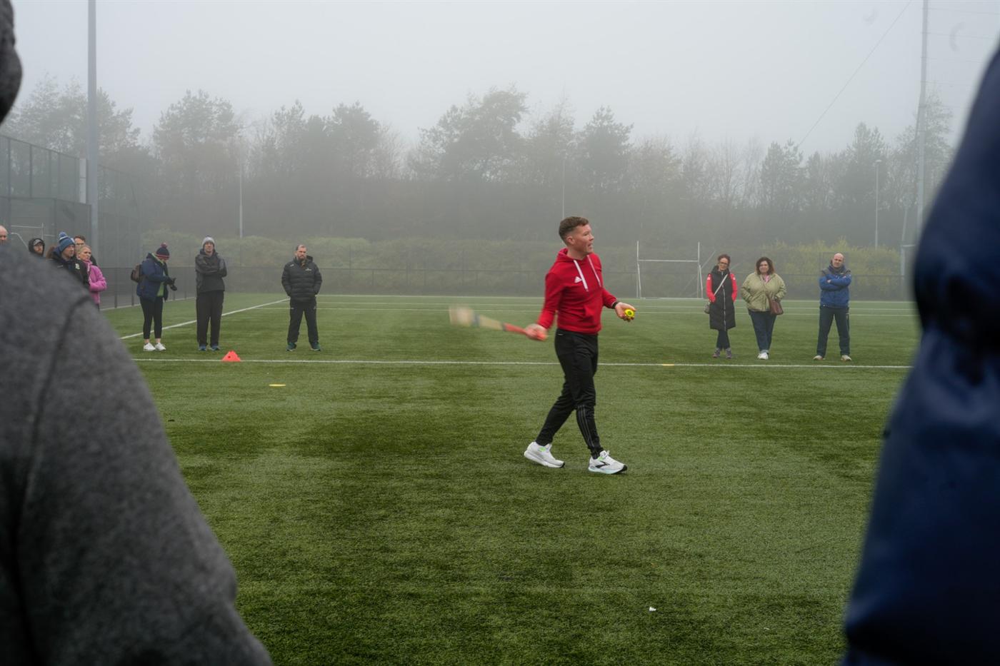 Shane demonstrating on the pitch with a hurl and sliotar